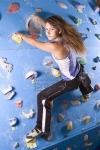 7697975-pretty-young-athletic-girl-climbing-on-an-indoor-rock-climbing-wall